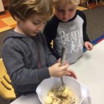 Kids mixing together some ingredients for school