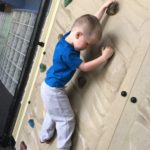 student climbing rockwall