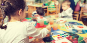 Kids coloring at their school table